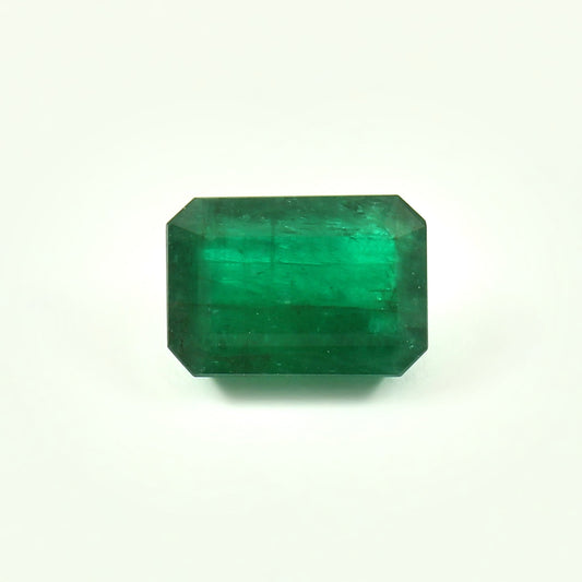 Comparison of lab-grown and natural emeralds in jewelry settings – emerald earrings and rings in a soft jewelry display